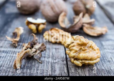 Walnuts kernels on a rustic old wooden table. Fresh walnuts. Harvest walnuts. Stock Photo