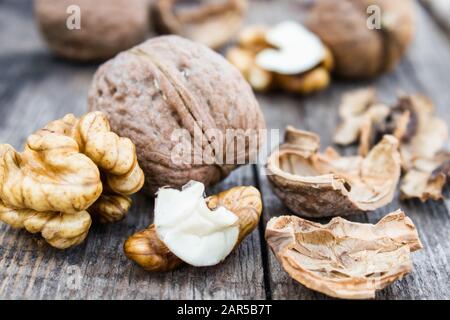 Walnuts kernels on a rustic old wooden table. Fresh walnuts. Harvest walnuts. Stock Photo