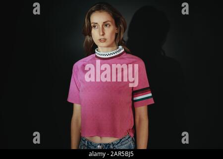 portrait of beautiful young woman wearing a pink shirt Stock Photo