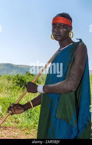 Mursi man. The Mursi (or Murzu) are a Sub-Saharan African nomadic cattle herder tribe located in the Omo valley in southwestern Ethiopia. Stock Photo