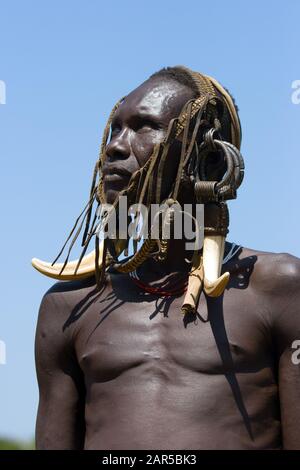 Mursi herder. The Mursi (or Murzu) are a Sub-Saharan African nomadic cattle herder tribe located in the Omo valley in southwestern Ethiopia. Stock Photo