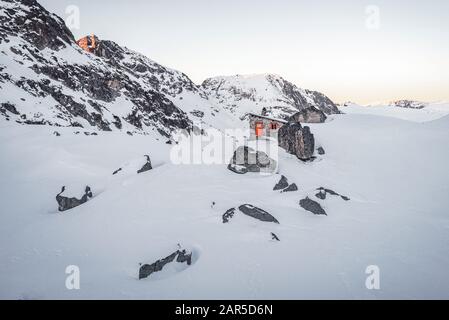 Scary lake shelter at winter in front of frozen lake in Rila mountain national park, Bulgaria Stock Photo