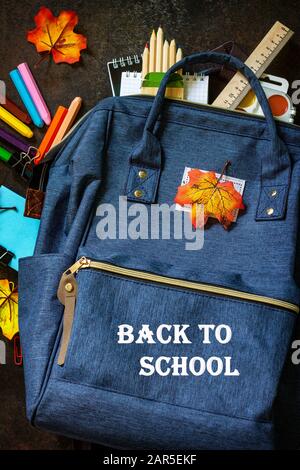 Back to school concept. School supplies with blue backpack on table. Top view flat lay. Stock Photo