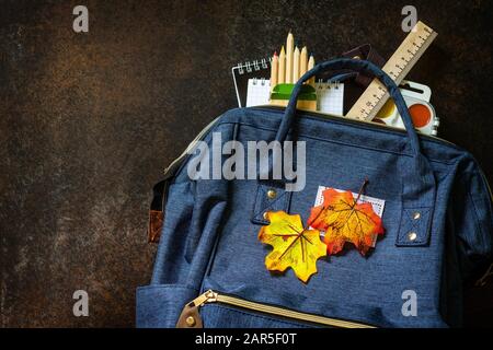 Back to school concept. School supplies with blue backpack on table. Top view flat lay. Free space for your text. Stock Photo