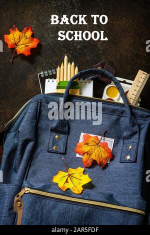 Back to school concept. School supplies with blue backpack on table. Top view flat lay. Stock Photo