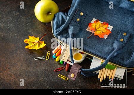 Back to school concept. School supplies with blue backpack on table. Free space for your text. Stock Photo