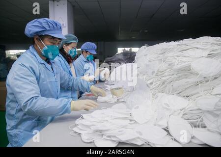Shanghai, China. 26th Jan, 2020. Workers count masks at Shanghai Yuanqin Purification Technology Co., Ltd. in Shanghai, east China, on Jan. 26, 2020. Workers at the company have been working extra hours to make masks, which will be used to combat the novel coronavirus outbreak. Credit: Ding Ting/Xinhua/Alamy Live News Stock Photo
