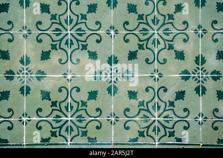 Traditional ornate portuguese decorative tiles (azulejos) on a building facade - close up photo in green colors Stock Photo