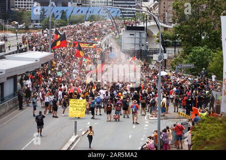 Protesters march across Victoria Bridge towards South Bank as they do a traditional smoking ceremony during the rally.Indigenous Yuggera and Turrbal people organised a rally known as Meanjin on a date synonymous with the beginning of British colonial rule and oppression of Aboriginal people. Other themes discussed at the rally included a fight against injustice and remembrance of the Stolen Generations and Aboriginal sovereignty. Stock Photo