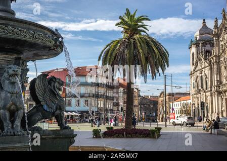 Fountain on Lion's Square in Vitoria parish of Porto city, second largest city in Portugal. Carmelite Church and Carmo churches on background Stock Photo