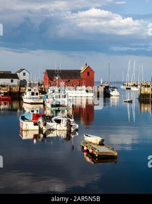 ROCKPORT, MASSACHUSETTS, USA-AUGUST 08, 2014:  A view of Rockport Harbor with blue sky  and the red building know as Motif Number One. Stock Photo