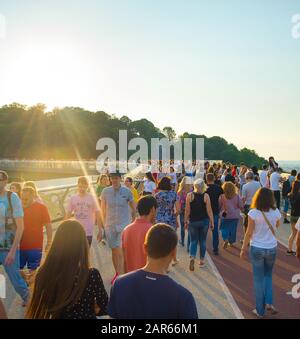 KIEV, UKRAINE - MAY 31, 2019:  Crowd of people at new Pedestrian-Bicycle Bridge at sunset. New Klitschko Pedestrian-Bicycle Bridge one of the most int Stock Photo