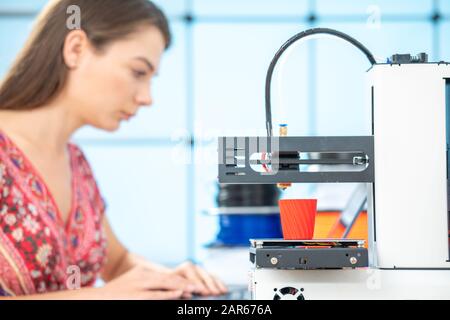 Young female designer works with a home 3D printer Stock Photo