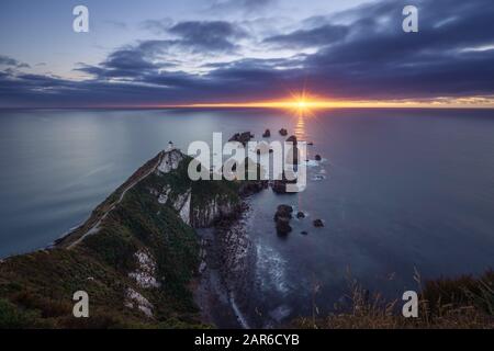 Beautiful sunrise at Nugget Point Lighthouse, New Zealand Stock Photo