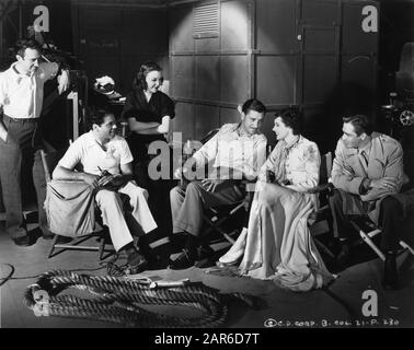 Left to right : Dialogue Director HAROLD WINSTON Director FRANK CAPRA MARGO RONALD COLMAN and JOHN HOWARD on set rehearsal candid during filming of LOST HORIZON 1937 novel JAMES HILTON screenplay ROBERT RISKIN Columbia Pictures Stock Photo