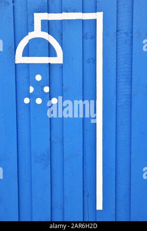 Handpainted shower signage on blue wooden boards, beachfront, isolated, portrait orientation Stock Photo