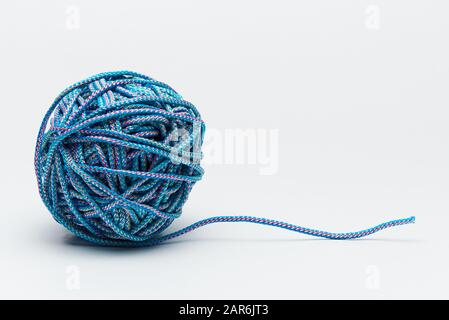 Blue rope and tangled clew on a white background. Stock Photo