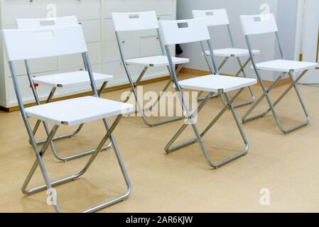 A row of empty chairs in the office of the clinic. Stock Photo