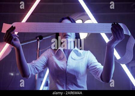 Electrocardiogram in the hands of a doctor in surgery. Stock Photo