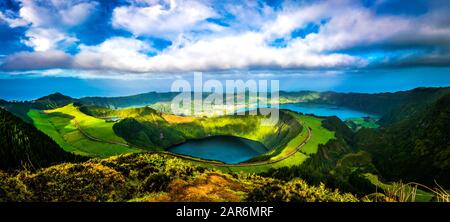 Panoramic view of 'Lagoa do Santiago', 'Lagoa Azul' and 'Sete cidades' from 'Grota do inferno' lookout with blue and cloudy sky Stock Photo