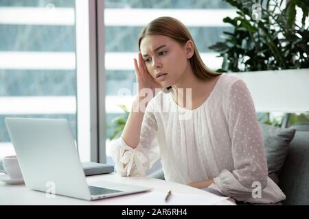 Stressed young office worker stuck with hard task. Stock Photo