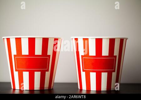 Striped box with popcorn on wood desk Stock Photo
