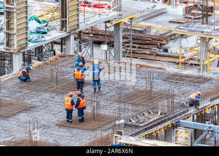 Saint Petersburg, Russia, October 31: Workers lay rebar to fill a concrete floor at a school construction site in Saint Petersburg, October 31, 2015. Stock Photo