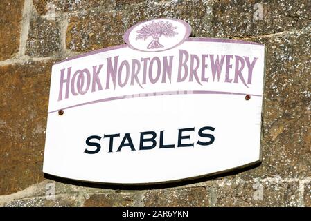 The Stables sign at the family owned Hooks Norton Brewery founded in 1849, in the village of Hook Norton village in the north Oxfordshire Cotswolds in Stock Photo