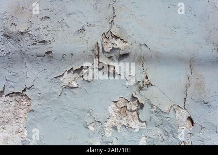 Faded paint on a blue wall with cracked paint. Stock Photo