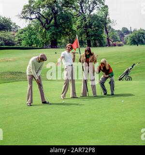 London 1970s, two couples playing golf, Royal Wimbledon Golf Club course, England, UK, GB, Great Britain, Stock Photo