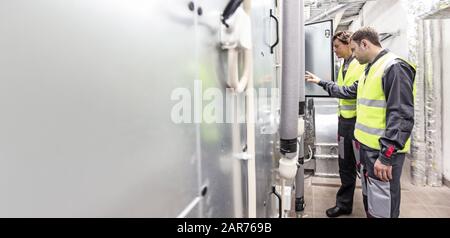 Electrician engineers working in electical cabinet control , switchboard operator Stock Photo