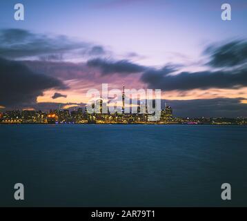 Skyline photo of Auckland. The photo was taken during sunset across the bay, New Zealand. Stock Photo