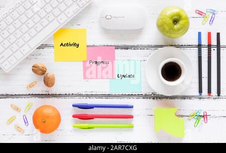 a workplace with colorful, motivating, saved cards. Concept, Achievement improvement. Keyboard, healthy snack, pens, bright background. Stock Photo