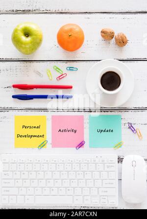 a workplace with colorful, motivating, saved cards. Concept, Achievement improvement. Keyboard, healthy snack, pens, bright background. Stock Photo