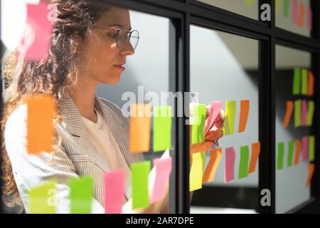 Close up of millennial female collaborate strategy on sticky notes Stock Photo