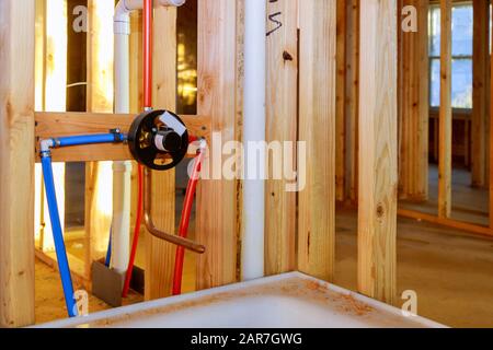 Bathroom remodel under plumbing work connecting installation shower faucet Stock Photo