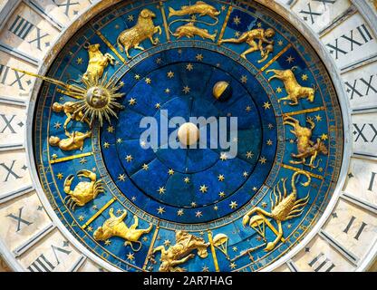 Ancient clock Torre dell'Orologio on St Mark's Square (San Marco) in Venice. Detail with clock face and astrological Zodiac signs. Vintage dial close- Stock Photo