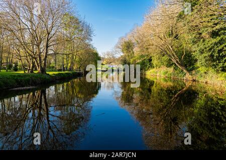 The River Nene at Wansford, Cambridgeshire, England, UK,  on a calm, sunny day in April with very clear reflections in the water Stock Photo