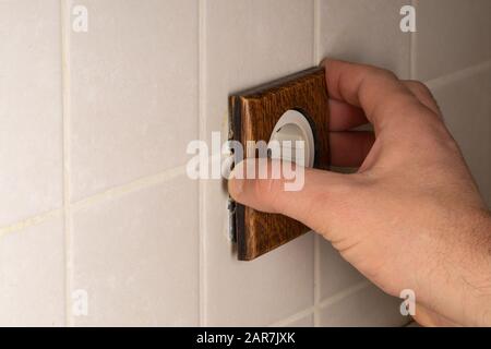 Electric double socket European standard and double switch with a wooden trim handmade. Vintage interior design in the loft style Stock Photo
