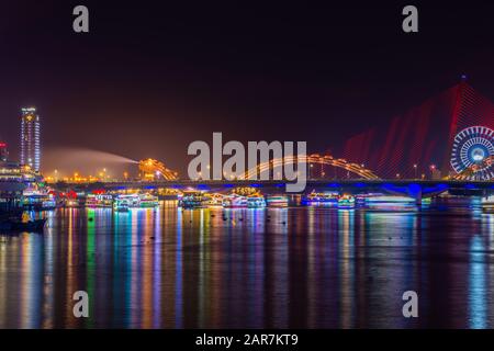 Dragon Bridge at night the icon of the Da Nang City, Vietnam. Dragon breathes out stream of water during weekend showtime. Stock Photo