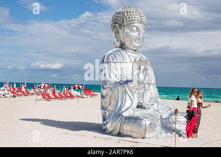 Miami Beach Florida,Atlantic Ocean,Art Basel Week,Faena District,cultural neighborhood,Buddha,monumental sculpture,Chinese artist Zhang Huan,woman,pos