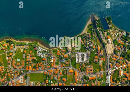 Aerial view of Como lake, Dongo, Italy. Coastline is washed by blue turquoise water Stock Photo