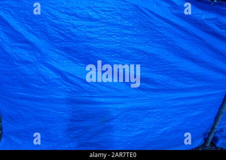 blue plastic tarp with folds Stock Photo