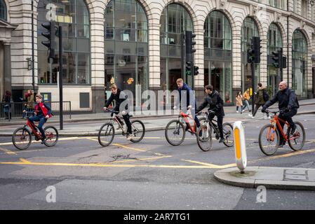 London cycling. Teenagers and one adult cycling careless and unprotected in the City of London, London, UK Stock Photo