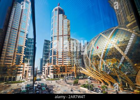 Elevated city view from a covered street overpass leading to the Hotel Grand Lisboa. Macau, China. Stock Photo