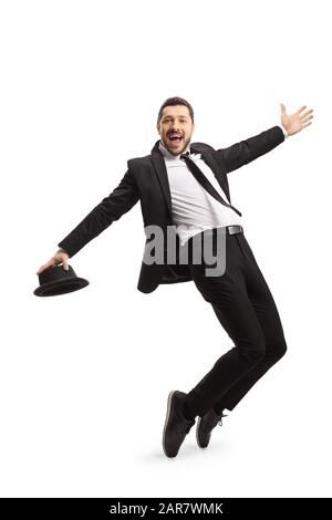 Full length shot of a guy in a suit dancing and singing isolated on white background Stock Photo