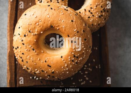 Sesame bagels on wooden board closeup view Stock Photo