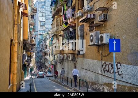 People walking on narrow street in historic centre. Macau, China. Stock Photo