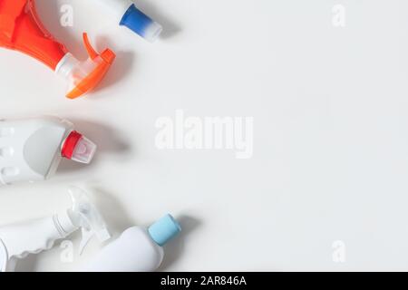 Colorful plastic bottles of detergent products on white background. Plastic recycling concept. Flat lay. Copy space. Plastic waste. Stock Photo