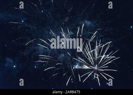 Bright blue fireworks against the dark sky. Stock Photo